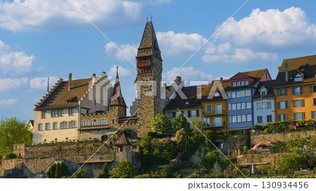 Historic buildings and tower in a picturesque landscape under a blue sky with clouds Historic buildings and tower in a picturesque landscape under a blue sky with clouds 130934456