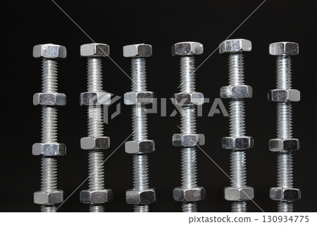 Steel Nuts At The Same Distance Between On A Long Threaded Metal Bars Texture Background Steel Nuts At The Same Distance Between On A Long Threaded Metal Bars Texture Background 130934775