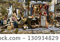 Scenes of daily life in an ancient Neapolitan nativity scene with figurines of food, fruit, and vegetable vendors. 130934829