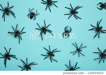 Halloween background with spiders as symbols of Halloween on the blue background. Happy Halloween concept 130934835