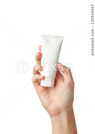 Hand holding blank white plastic tube isolated on white background. Cosmetic beauty product branding mockup. Vertical photo Hand holding blank white plastic tube isolated on white background. Cosmetic beauty product branding mockup. Vertical photo 130934847