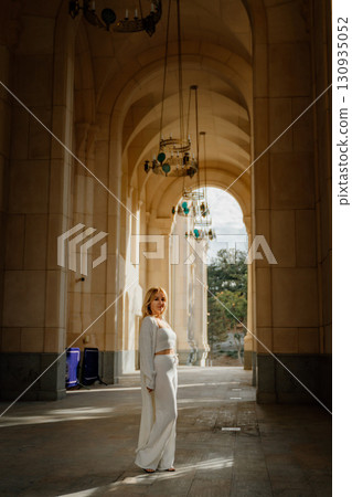 Woman, Cathedral, Tbilisi - A woman stands in the doorway of a cathedral in Tbilisi, Georgia, likely for a photo opportunity or to admire the architecture. 130935052