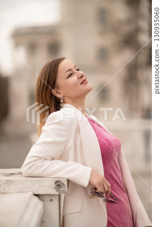 Woman Portrait Sunshine: Happy woman in pink smiles outdoors in daytime, enjoying fresh air and sunlight. Woman Portrait Sunshine: Happy woman in pink smiles outdoors in daytime, enjoying fresh air and sunlight. 130935060