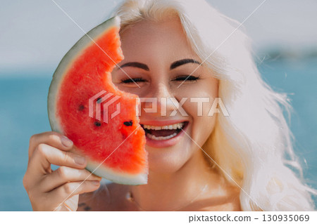 Watermelon Woman Summer Beach: Happy blonde enjoys refreshing watermelon slice near ocean, summer fun. Watermelon Woman Summer Beach: Happy blonde enjoys refreshing watermelon slice near ocean, summer fun. 130935069