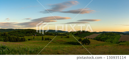 Landscape of the hills on the outskirts of Kamienna Gora during beautiful sunset on a summer afternoon, Lower Silesia, Poland. Landscape of the hills on the outskirts of Kamienna Gora during beautiful sunset on a summer afternoon, Lower Silesia, Poland. 130935114