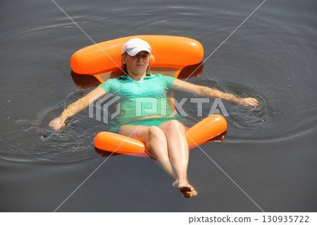 Attractive woman in swimsuit swaying in hammock enjoying summer holidays 130935722