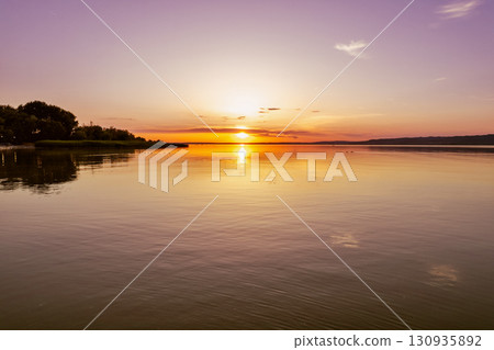 Spectacular sunset over lake Balaton with golden reflections, Hungary. 130935892