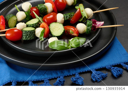 Vegetable and mozzarella cheese canapes on skewers Vegetable and mozzarella cheese canapes on skewers 130935914