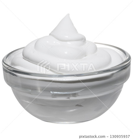 A portion of thick sour cream or yogurt in a transparent glass bowl, arranged in the form of a spiral, isolated background 130935937
