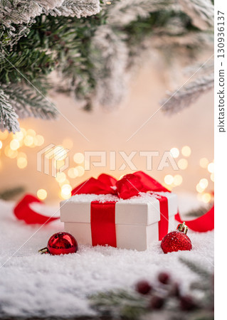 Christmas Gift and Ornaments on Snow with Tree Branches Christmas Gift and Ornaments on Snow with Tree Branches 130936137