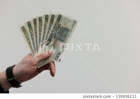 Man holding a fan from 100 bills banknotes of Polish zloty. Man holding a fan from 100 bills banknotes of Polish zloty. 130936211