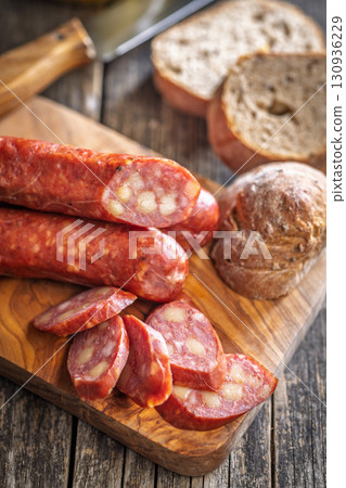 Sliced smoked sausage on cutting board. Sliced smoked sausage on cutting board. 130936229