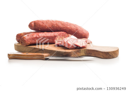 Sliced smoked sausage isolated on white background. Sliced smoked sausage isolated on white background. 130936249