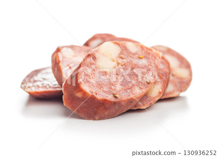 Sliced smoked sausage isolated on white background. Sliced smoked sausage isolated on white background. 130936252