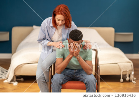 Unhappy diverse couple discussing divorce at home, solving marriage problems Unhappy diverse couple discussing divorce at home, solving marriage problems 130936436