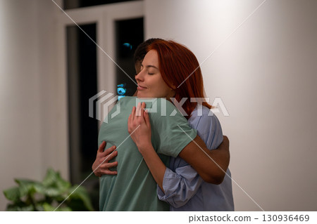 Loving supportive husband embracing his wife gently at home. Love and support in relationships Loving supportive husband embracing his wife gently at home. Love and support in relationships 130936469