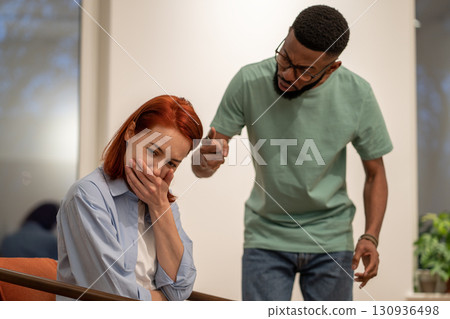 Nervous angry husband black man screaming try to explain prove something to hysterical woman wife. 130936498