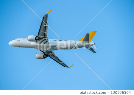 Passenger airplane flight in blue sky bottom view. Travel concept. Passenger airplane flight in blue sky bottom view. Travel concept. 130936504