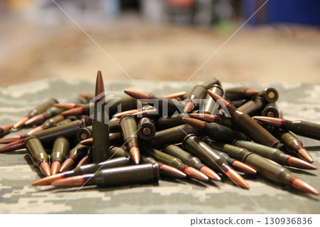 Cartridges for Kalashnikov assault rifle. War Concept. Heap of billets 130936836