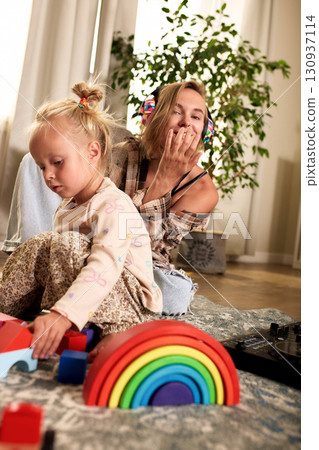 Mother and Daughter Playing Together Indoors With Colorful Educational Toys 130937114