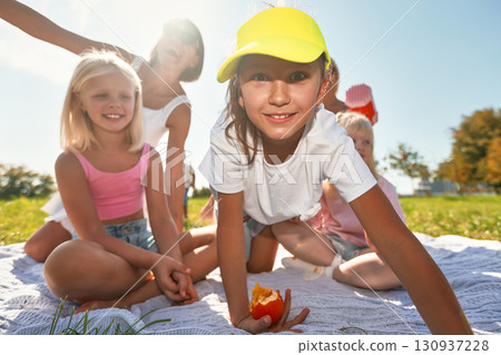 Children enjoying a sunny day outdoors with laughter and joy 130937228