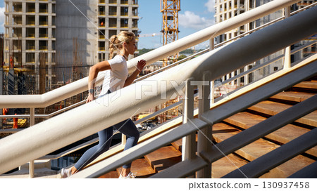 Woman Running Upstairs in an Urban Construction Environment 130937458