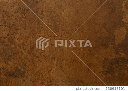 Textured brown surface with earthy tones showcasing natural imperfections and variation in hue and 130938101