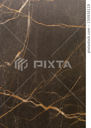 Elegant dark marble with golden veins displaying a luxurious texture ideal for modern interior 130938119