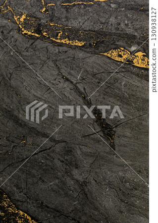 Striking black and gold marble texture with intricate patterns showcasing natural beauty and Striking black and gold marble texture with intricate patterns showcasing natural beauty and 130938127