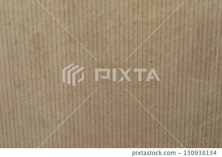 Textured surface of corrugated cardboard displaying a warm, earthy tone and subtle lines in natural Textured surface of corrugated cardboard displaying a warm, earthy tone and subtle lines in natural 130938134