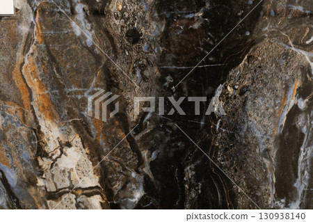 Unique natural stone surface showcasing intricate patterns and colors from a geological formation Unique natural stone surface showcasing intricate patterns and colors from a geological formation 130938140