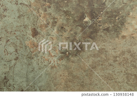 Textured surface resembling aged stone with earthy tones and subtle color variations 130938148