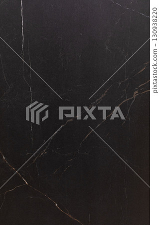 Dark marble surface with intricate veining pattern enhancing modern interior design aesthetics Dark marble surface with intricate veining pattern enhancing modern interior design aesthetics 130938220