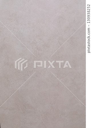 Textured wall surface with subtle pattern in soft neutral tones enhances contemporary interior 130938252
