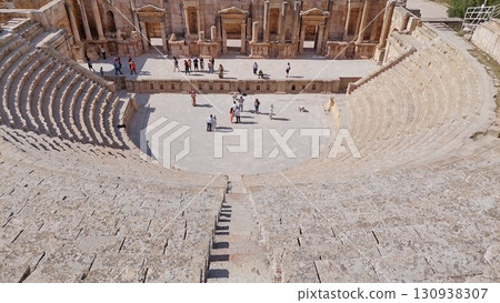 Tourists explore the ancient Roman theater in Jerash 130938307