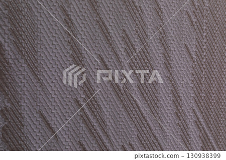 Close-up view of textured wall surface displaying unique patterns and color variations in natural 130938399