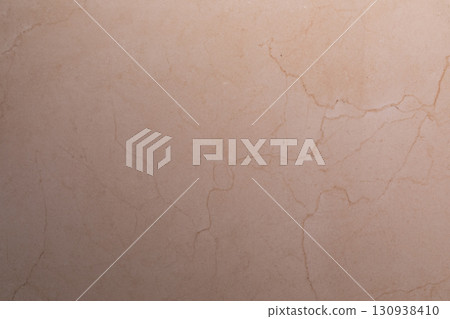 Textured beige stone surface with subtle cracks and patterns in natural light creates a calming Textured beige stone surface with subtle cracks and patterns in natural light creates a calming 130938410