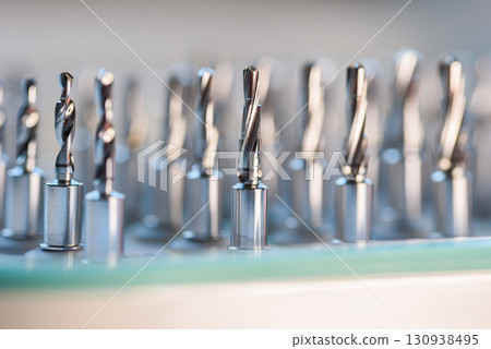 Full set of dental implant drill bits in surgical tray, close-up of professional dentistry equipment 130938495