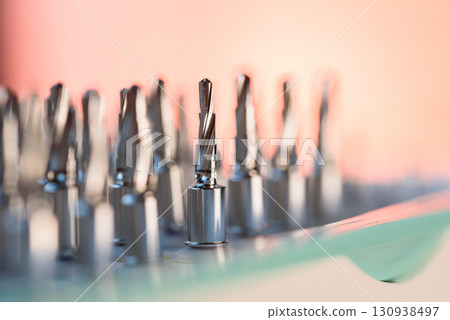 Full set of dental implant drill bits in surgical tray, close-up of professional dentistry equipment 130938497