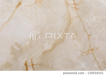 Elegant beige marble surface with delicate gold veins and a polished finish showcasing natural Elegant beige marble surface with delicate gold veins and a polished finish showcasing natural 130938581