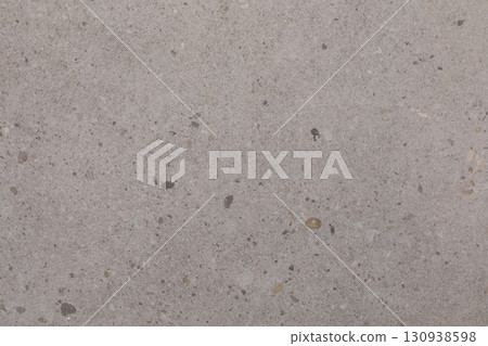 Light gray concrete surface with small stones and textures showing natural patterns and variations Light gray concrete surface with small stones and textures showing natural patterns and variations 130938598