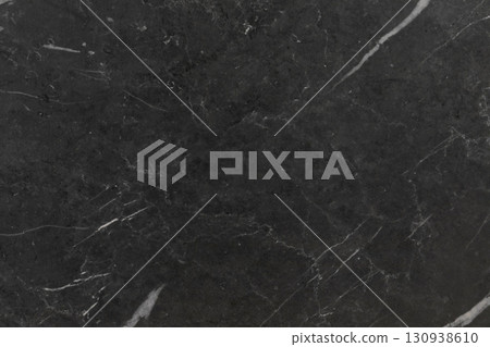 Dark marble surface with white veins showcasing a sleek, elegant texture for modern design projects 130938610