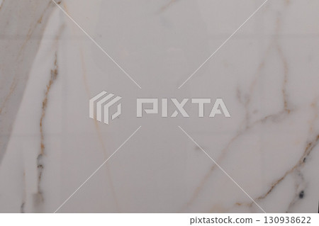 Elegant white marble surface with natural veining and smooth texture in soft lighting for interior 130938622