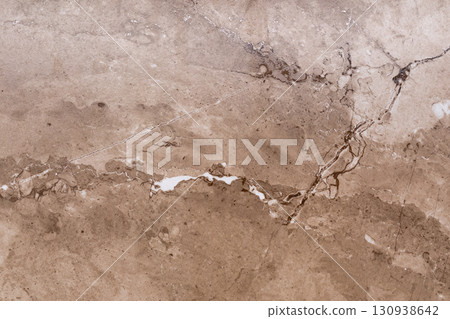 Natural stone texture with intricate patterns and warm tones showcasing beige and brown hues in 130938642
