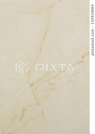 Light beige marble surface with subtle patterns and variations in texture and color displaying 130938664