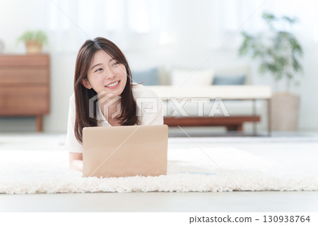 Young woman using a personal computer 130938764