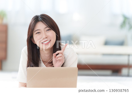 Young woman using a personal computer 130938765