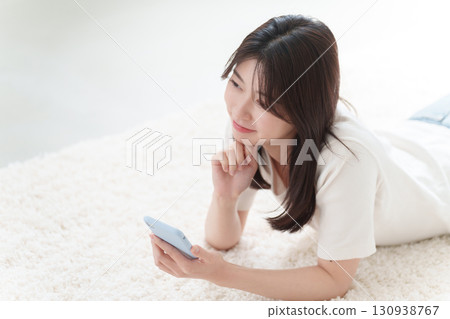 A young woman using a smartphone A young woman using a smartphone 130938767