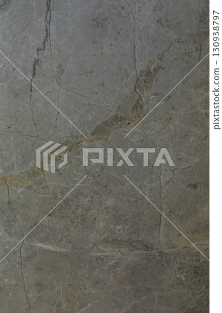 Detailed close-up of textured stone surface with natural cracks and lines highlighting its unique 130938797