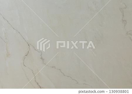 Smooth, light marble surface showing subtle veins and textures highlighting natural beauty and 130938801